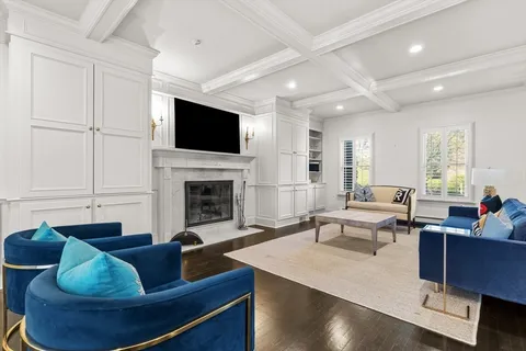 a living room with furniture fireplace and flat screen tv