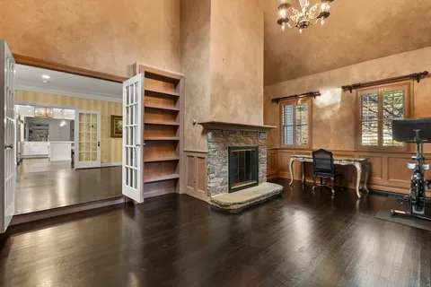 a living room with furniture wooden floor and a fireplace
