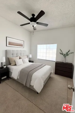 a bedroom with a bed and a ceiling fan