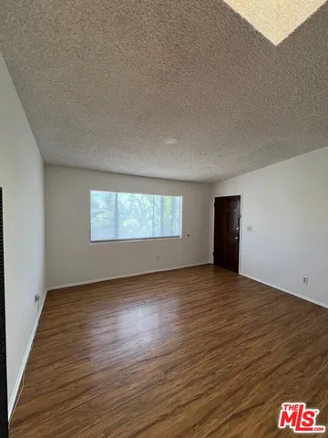 a view of an empty room and a window