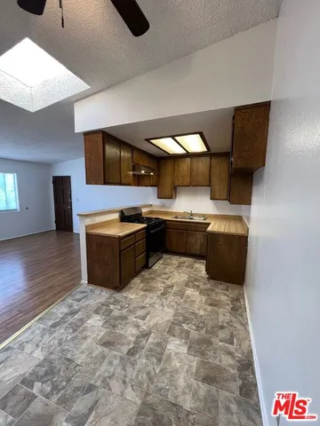 a kitchen with stainless steel appliances granite countertop a sink and a stove