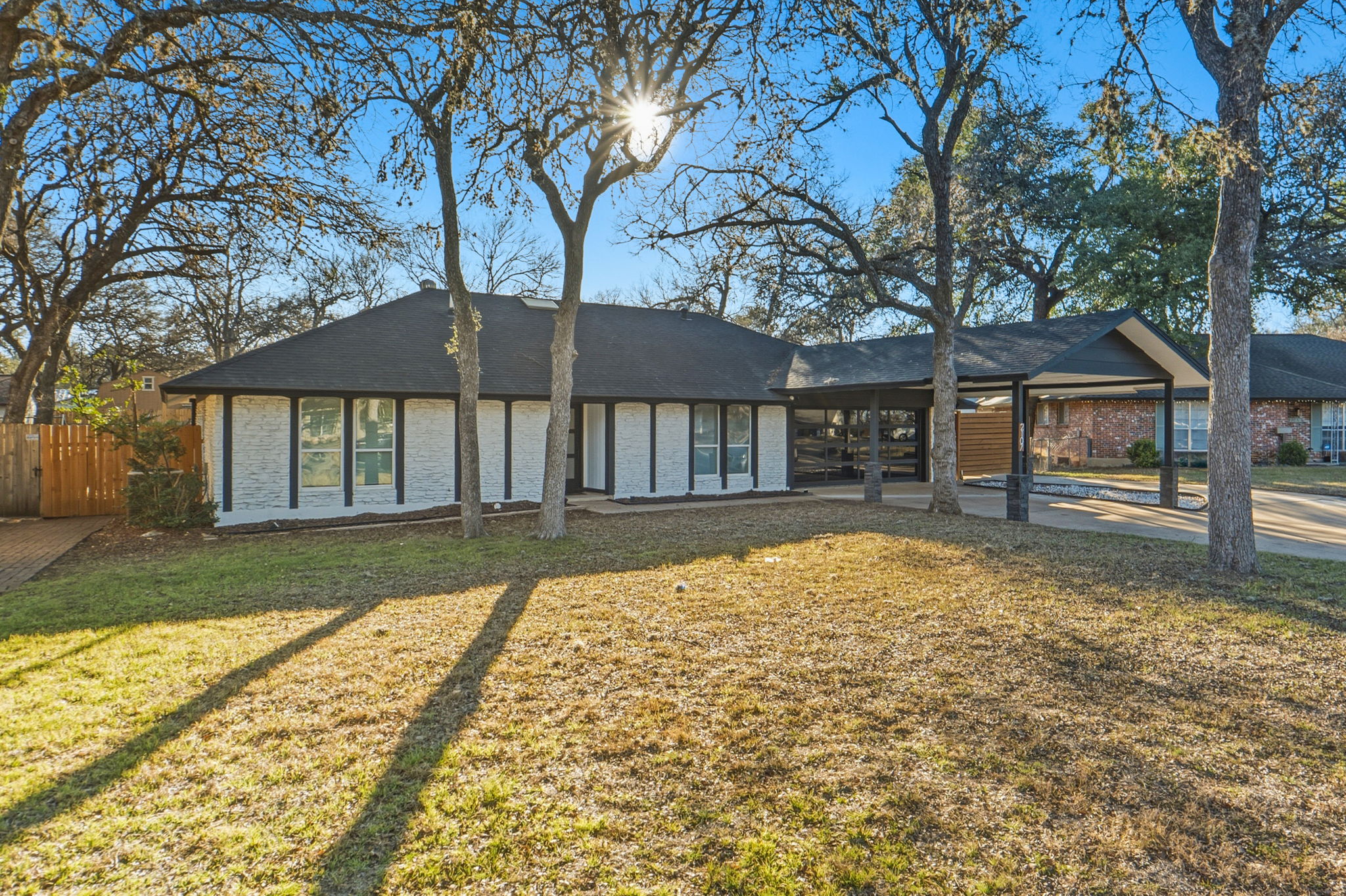 2107 Lewood Circle Austin, TX 78745 - Photo 2 of 30 View of front facade with an attached carport and brick siding