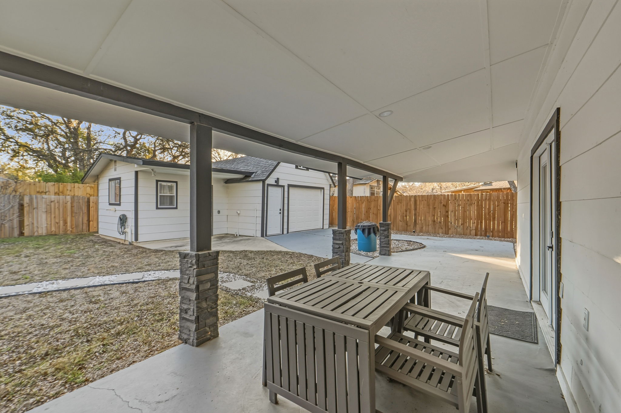 2107 Lewood Circle Austin, TX 78745 - Photo 23 of 30 Fenced backyard with a patio, an outdoor structure, and outdoor dining space
