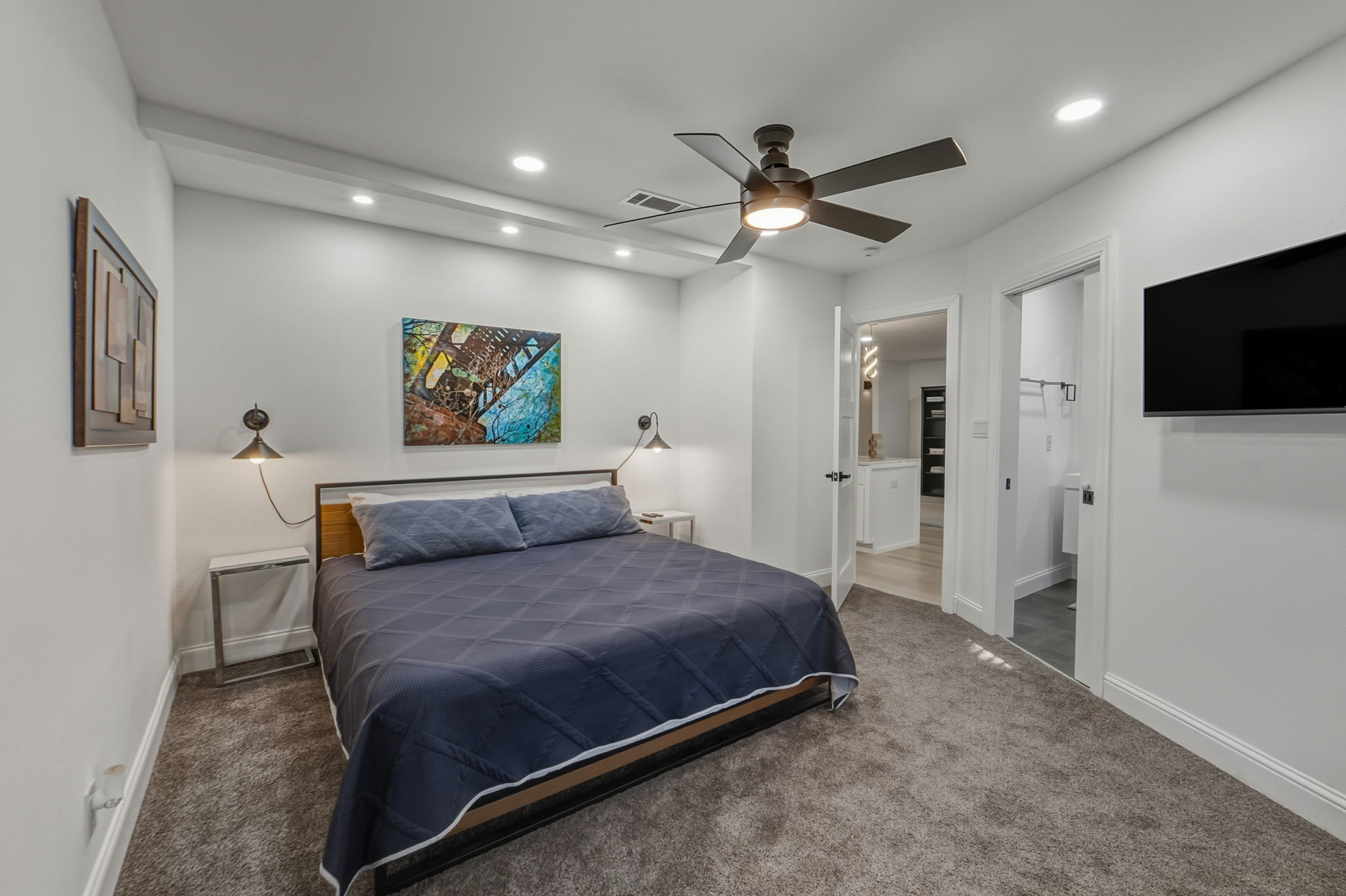 2107 Lewood Circle Austin, TX 78745 - Photo 10 of 30 Bedroom with ensuite bathroom, carpet flooring, a ceiling fan, and recessed lighting
