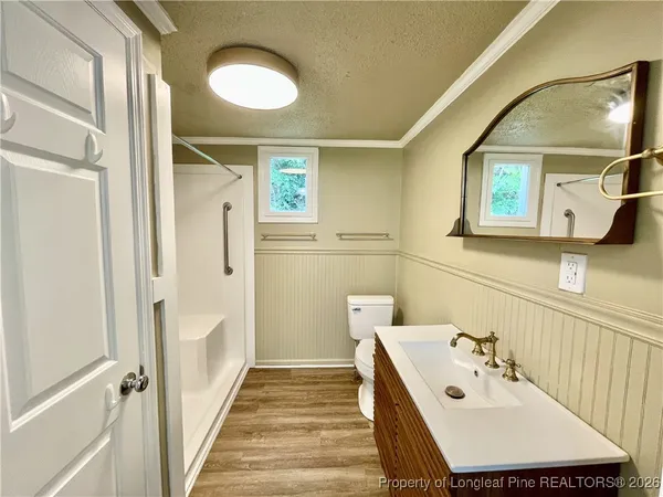 a bathroom with a glass door shower a sink and a mirror