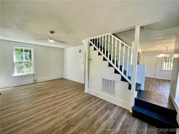 a view of an entryway with wooden floor and stairs
