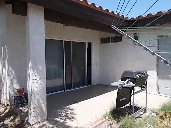 a balcony with table and chairs