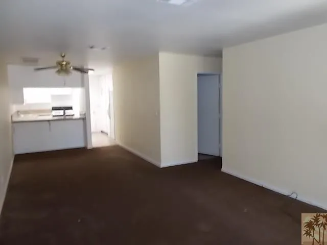 a view of a kitchen with a sink dishwasher and a fireplace