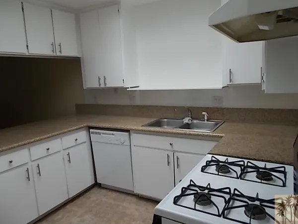 a kitchen with sink and cabinets