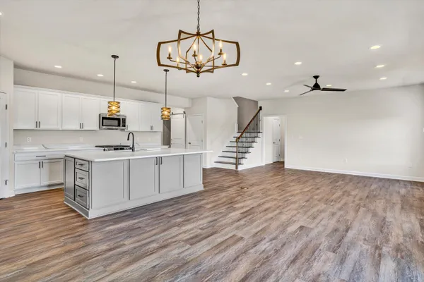 a kitchen with a sink cabinets and wooden floor