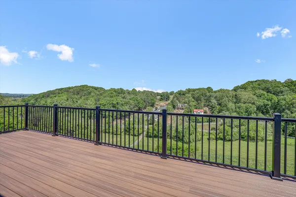 a view of balcony with wooden floor and fence