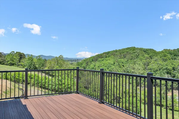 a view of balcony with wooden floor and fence