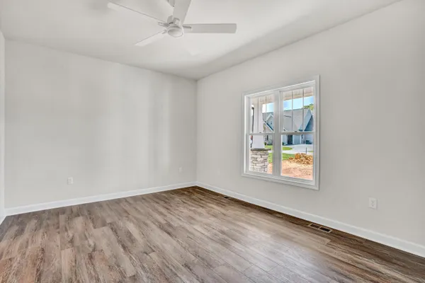 wooden floor in an empty room with a window