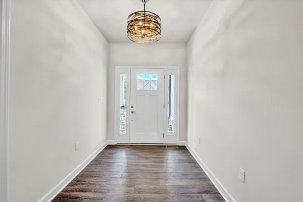 a view of an entryway with wooden floor