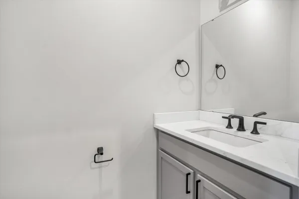 a bathroom with a sink and mirror