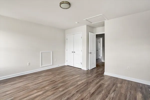 a view of an empty room and wooden floor