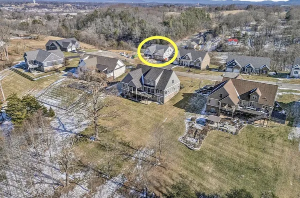 an aerial view of a swimming pool with outdoor seating