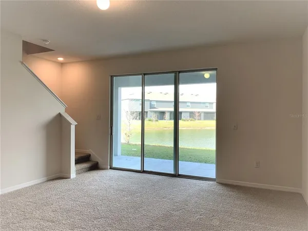 an empty room with large windows