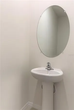 a bathroom with a sink a mirror and a toilet