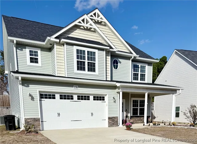 a view of a white house with large windows