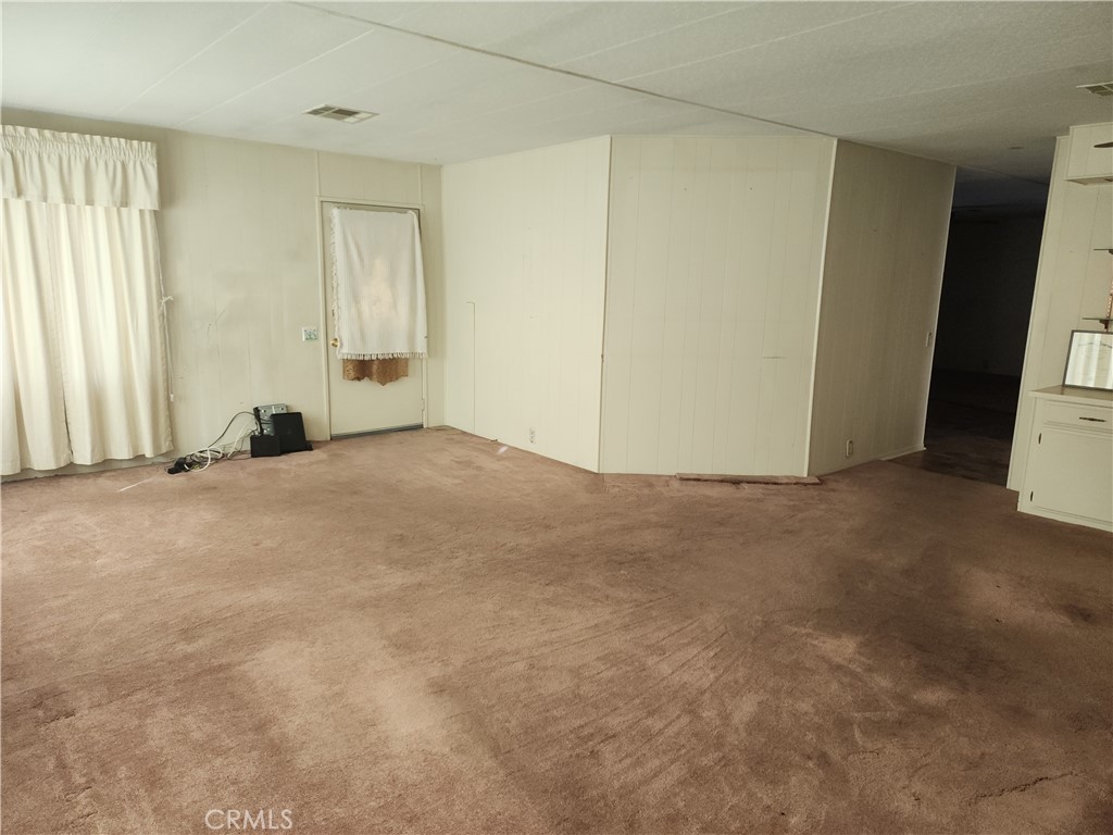 13393 Mariposa Road, Unit 181 Victorville, CA 92395 - Photo 12 of 19 an empty room with windows