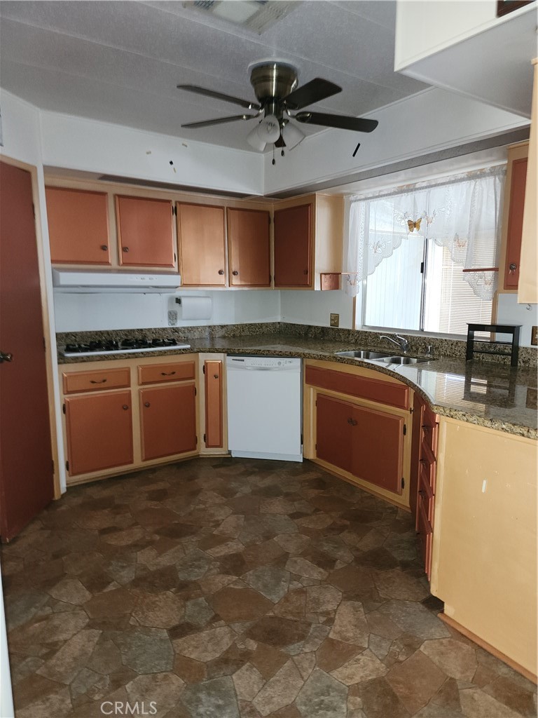 13393 Mariposa Road, Unit 181 Victorville, CA 92395 - Photo 15 of 19 a kitchen with stainless steel appliances granite countertop a sink stove and refrigerator