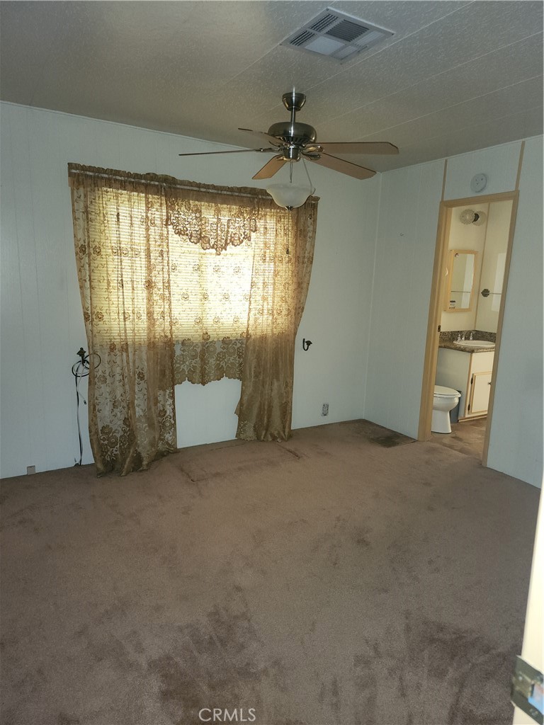 13393 Mariposa Road, Unit 181 Victorville, CA 92395 - Photo 17 of 19 an empty room with a window