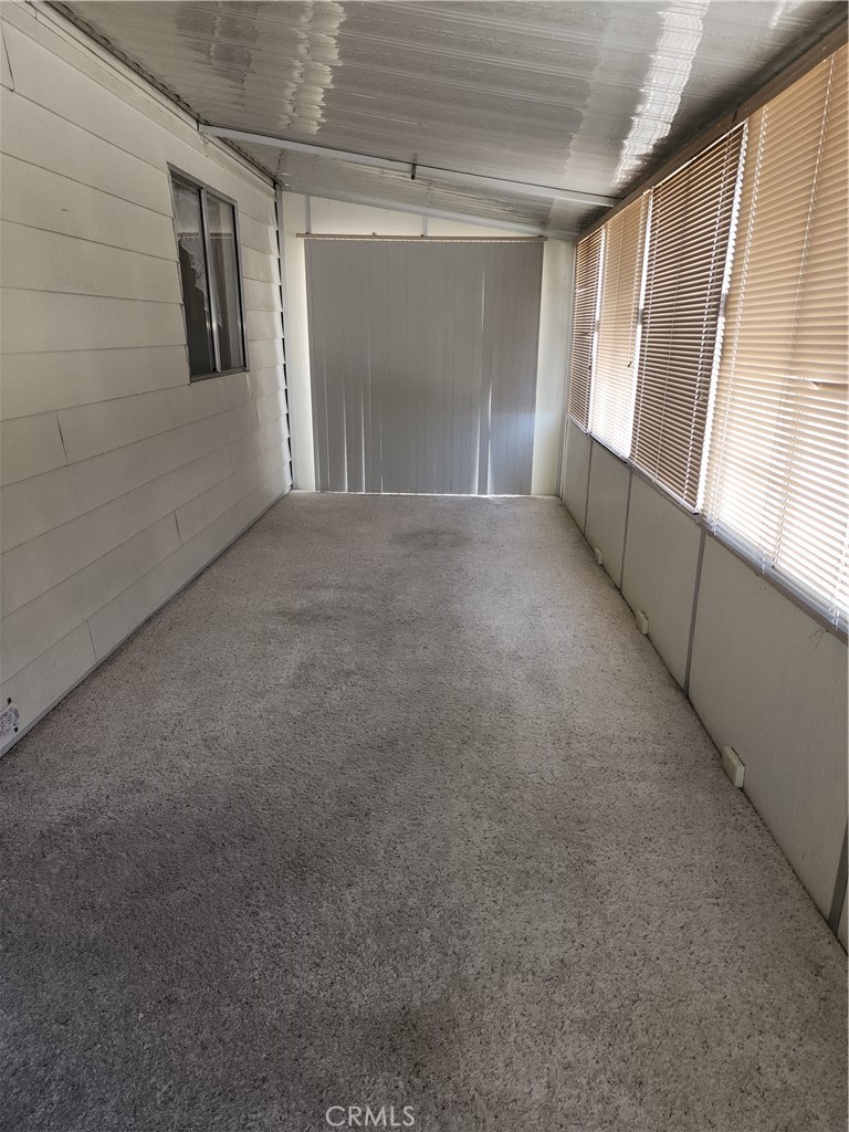 13393 Mariposa Road, Unit 181 Victorville, CA 92395 - Photo 9 of 19 a view of an empty room with a window