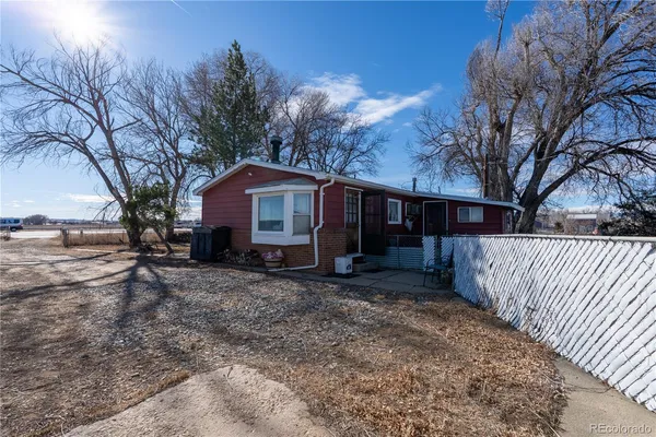 a view of a house with a yard covered in snow