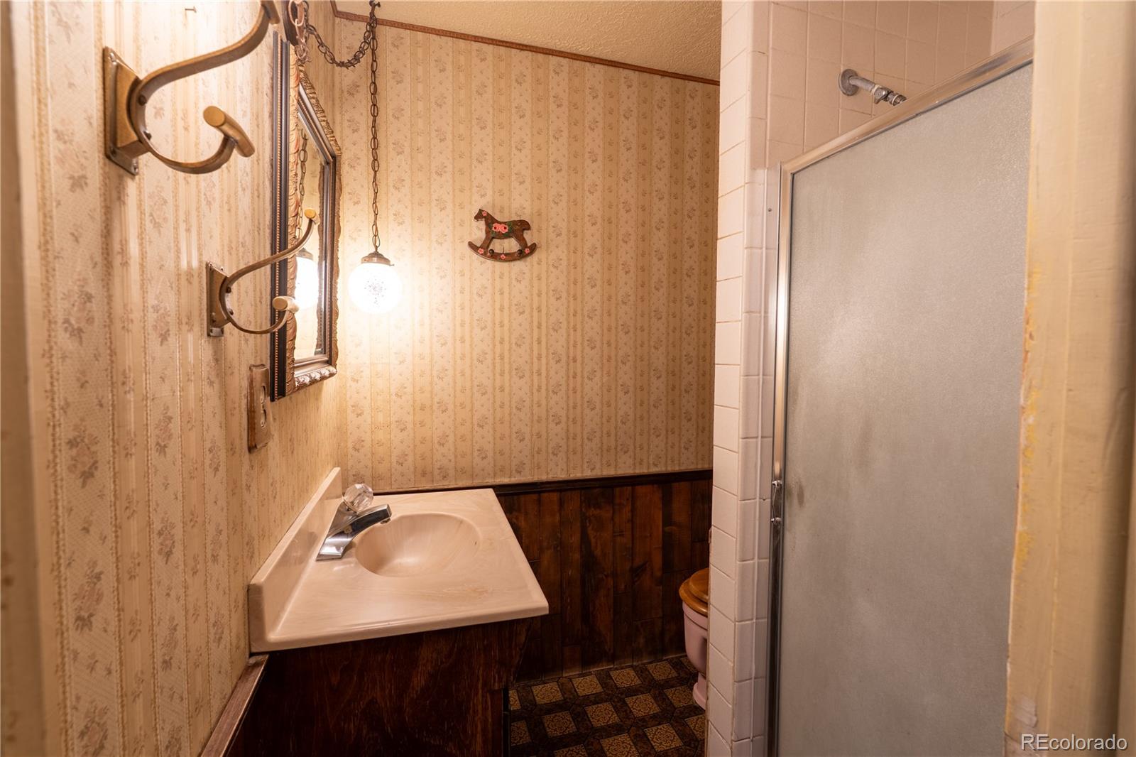 12169 East Baseline Road Lafayette, CO 80026 - Photo 13 of 32 a bathroom with a sink and a mirror