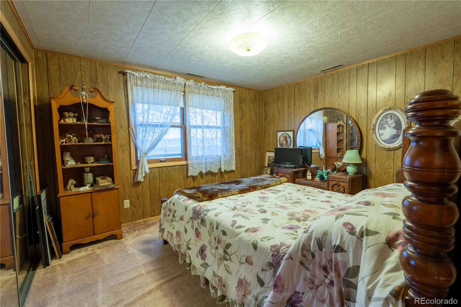 12169 East Baseline Road Lafayette, CO 80026 - Photo 15 of 32 a bedroom with a bed and a dresser next to a window