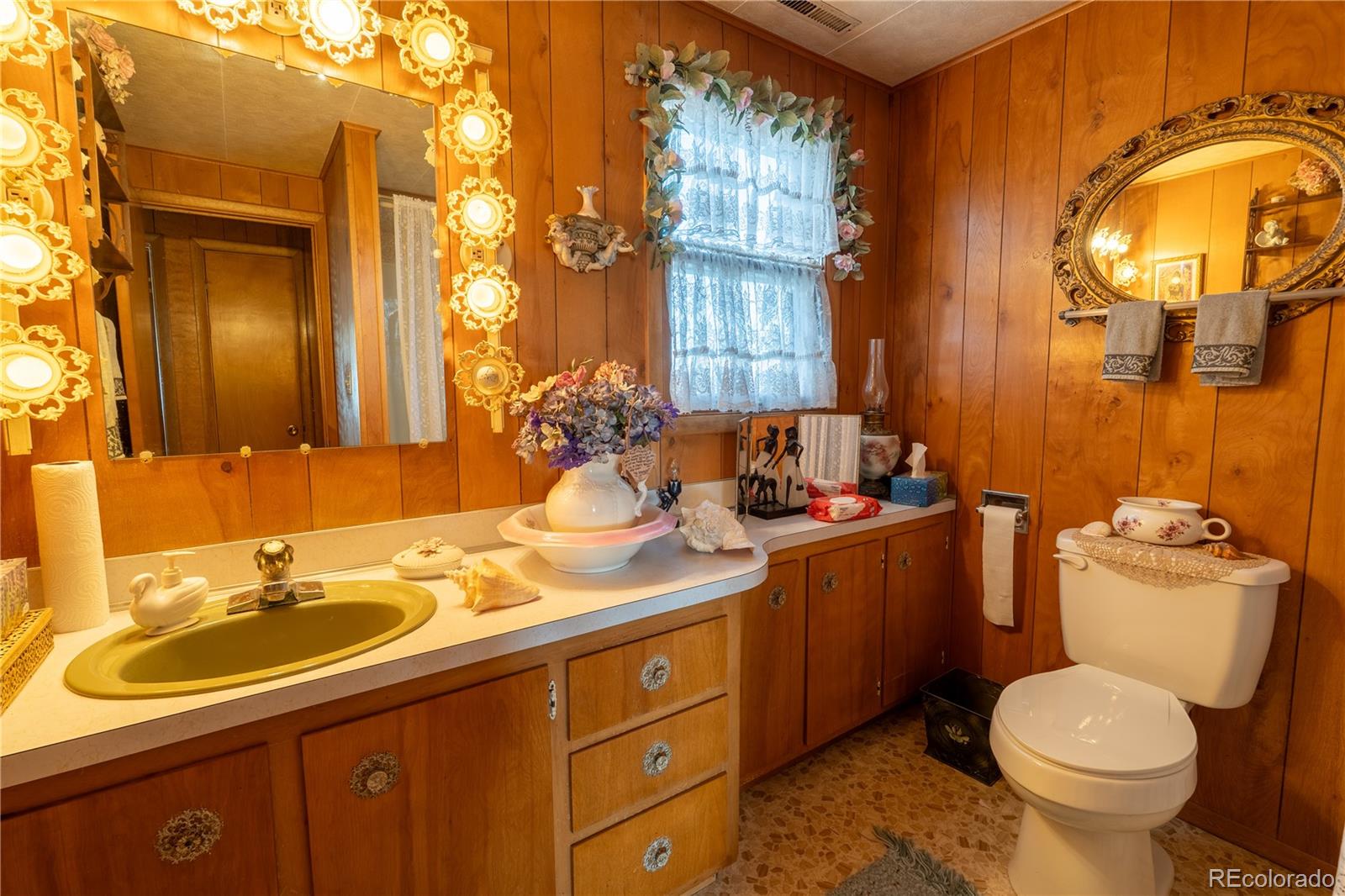 12169 East Baseline Road Lafayette, CO 80026 - Photo 16 of 32 a bathroom with a sink and a mirror