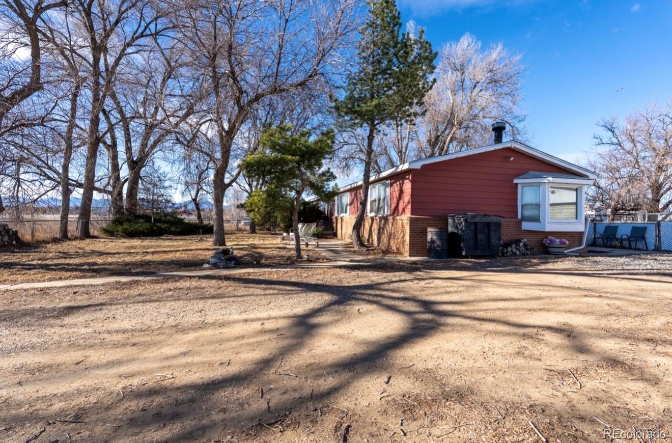 12169 East Baseline Road Lafayette, CO 80026 - Photo 21 of 32 a front view of a house with a yard