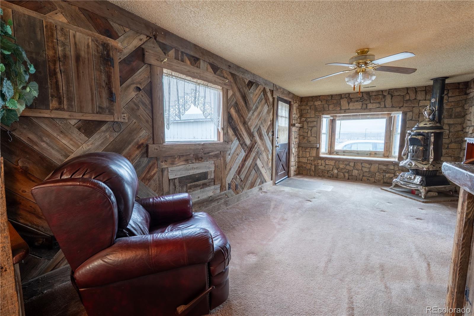 12169 East Baseline Road Lafayette, CO 80026 - Photo 3 of 32 a living room with furniture a window and a ceiling fan