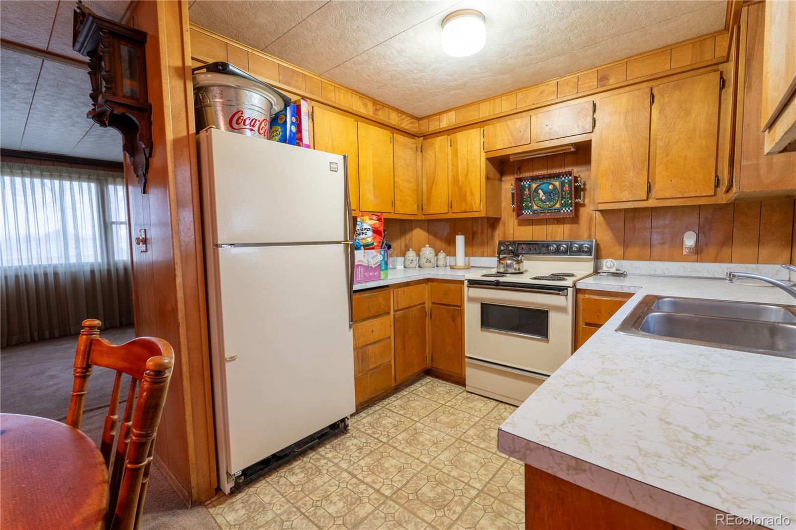 12169 East Baseline Road Lafayette, CO 80026 - Photo 8 of 32 a kitchen with stainless steel appliances granite countertop a refrigerator a stove and a sink with wooden floor