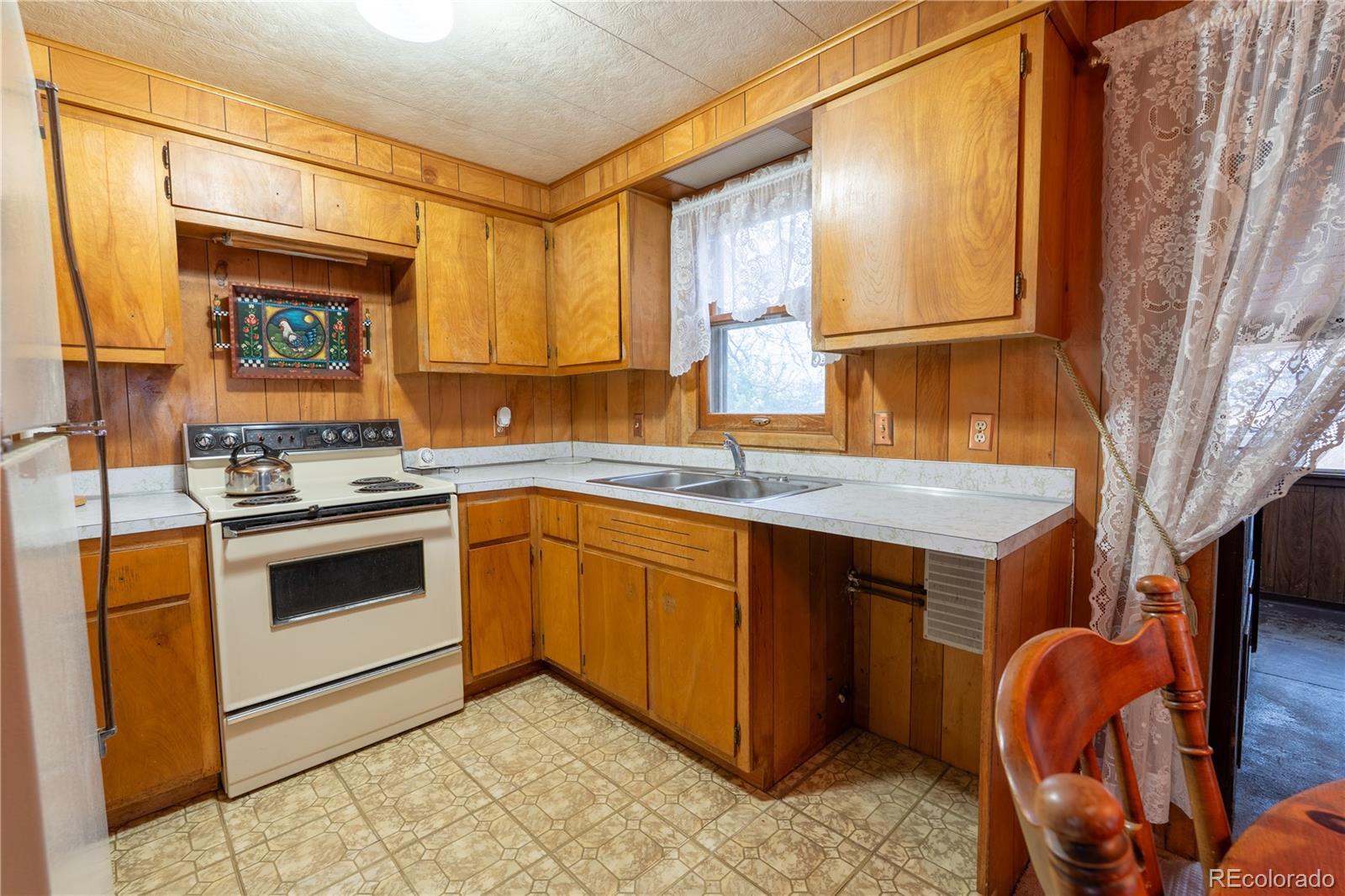 12169 East Baseline Road Lafayette, CO 80026 - Photo 9 of 32 a kitchen with stainless steel appliances granite countertop a sink and a stove