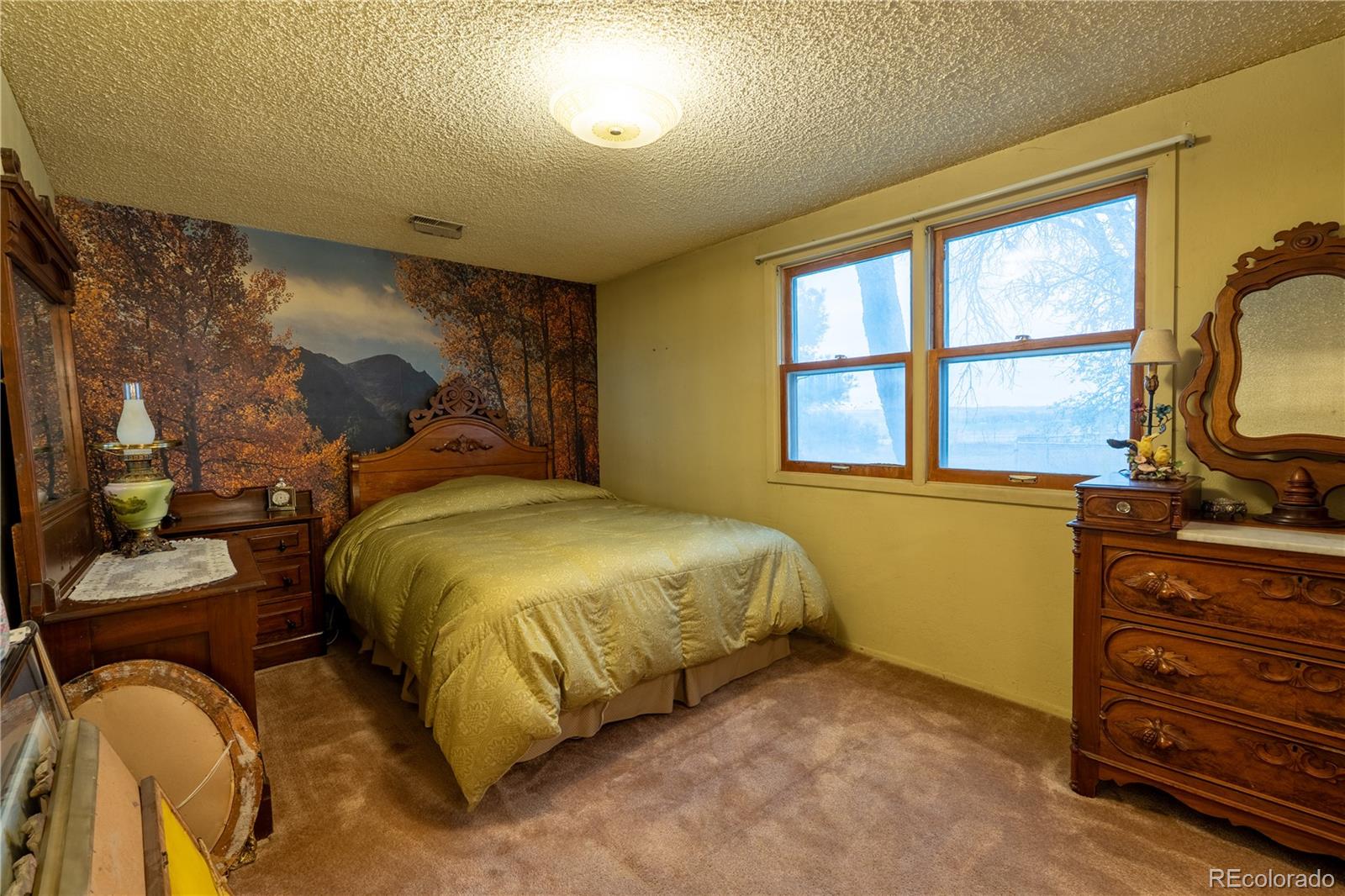 12169 East Baseline Road Lafayette, CO 80026 - Photo 10 of 32 a bed sitting in a bedroom next to a window
