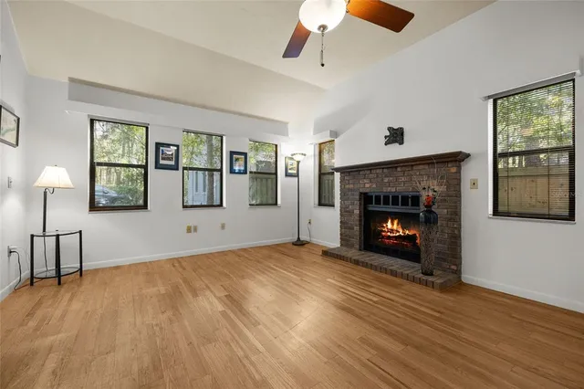 a view of empty room with wooden floor and fireplace