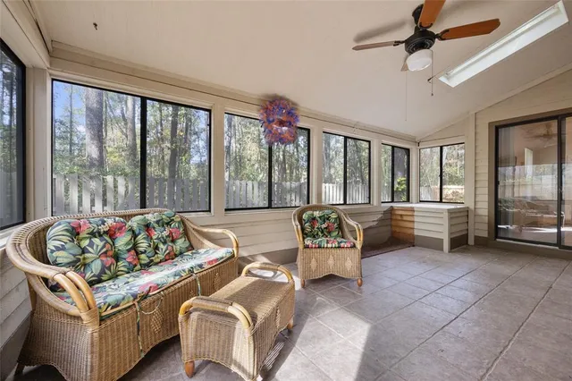 a living room with furniture and a floor to ceiling window