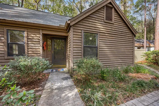 a view of a house with a yard and plants