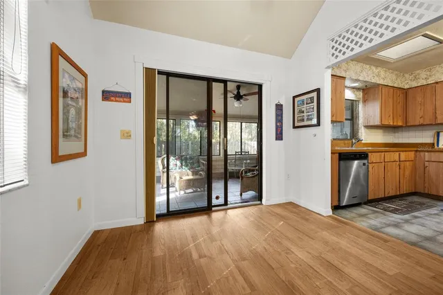 a view of a kitchen with wooden floor and a sink