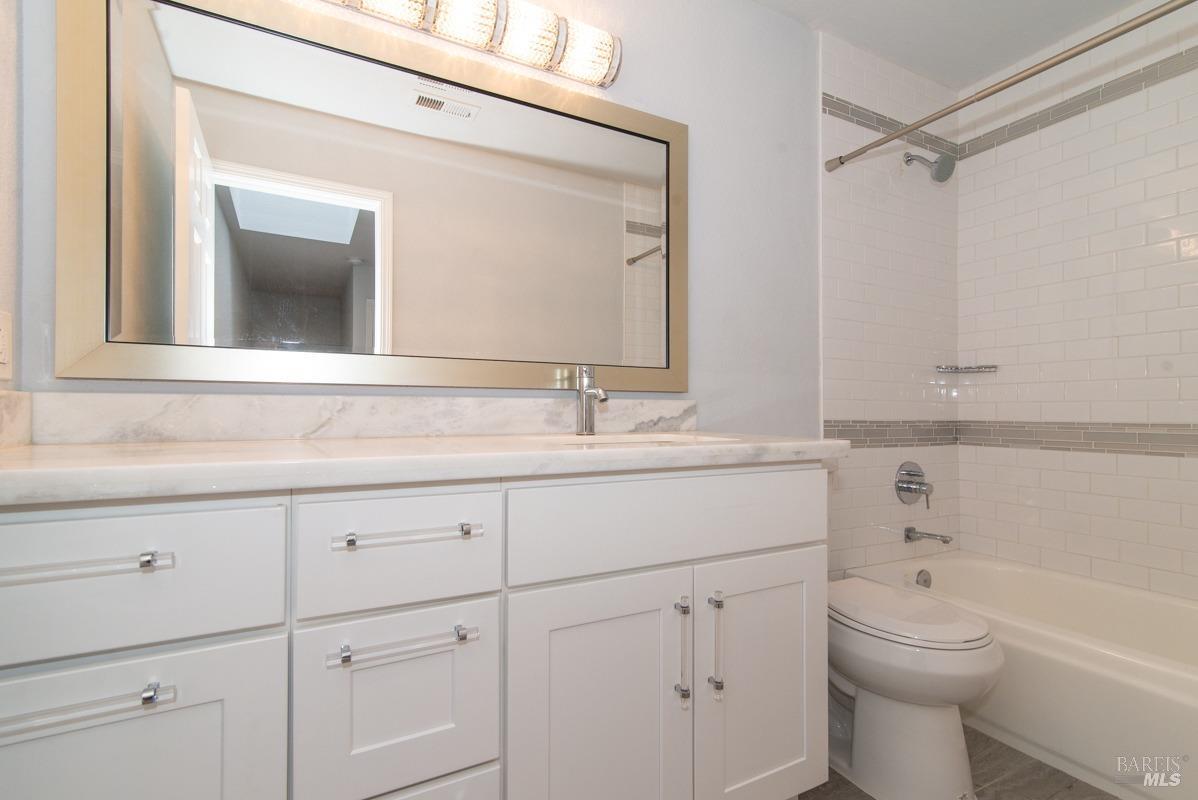 23 Baypoint Drive San Rafael, CA 94901 - Photo 19 of 40 a bathroom with a sink a toilet and a mirror