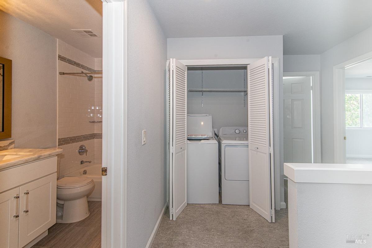 23 Baypoint Drive San Rafael, CA 94901 - Photo 20 of 40 a bathroom with a granite countertop toilet a sink and a mirror