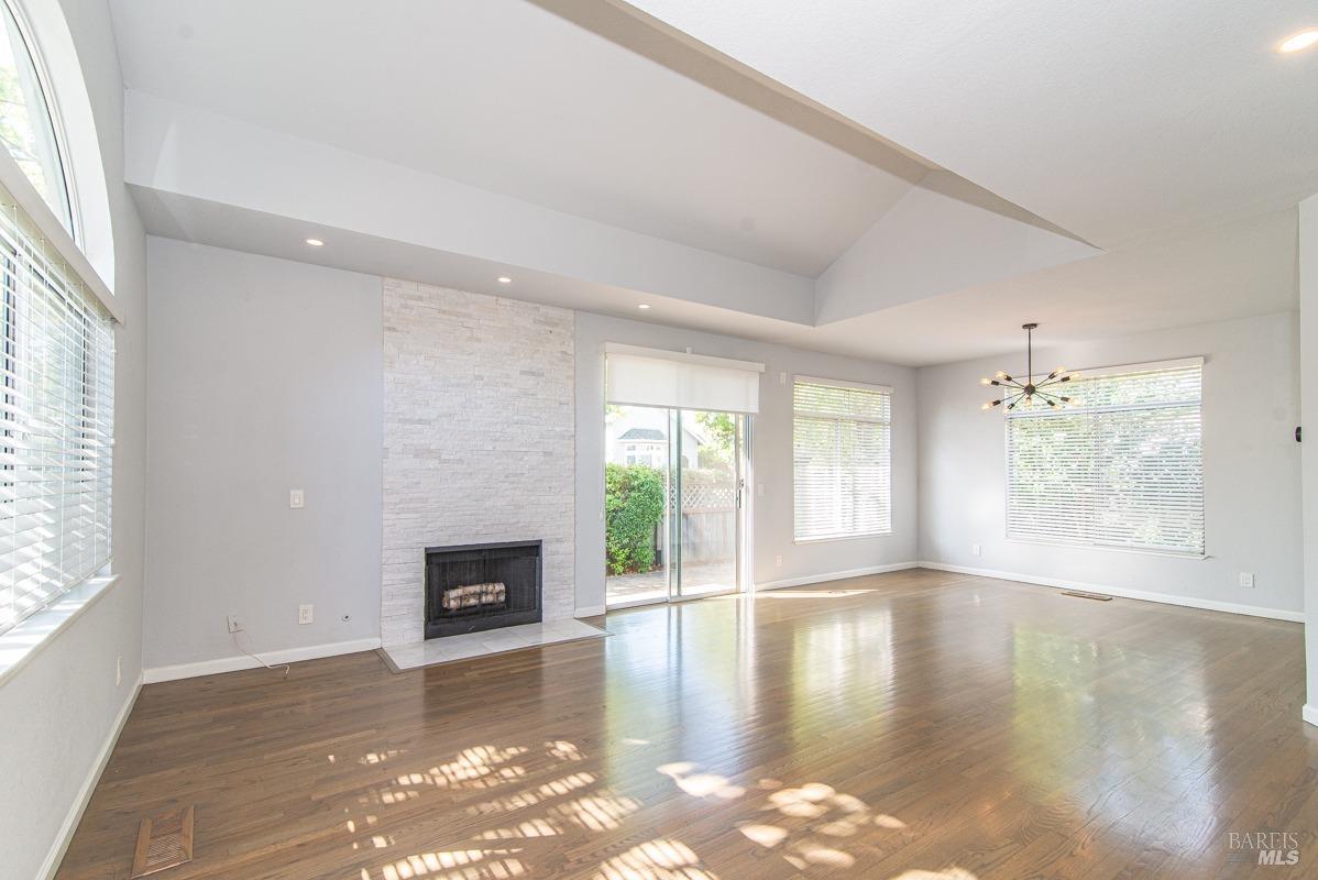 23 Baypoint Drive San Rafael, CA 94901 - Photo 2 of 40 a view of empty room with wooden floor and fireplace