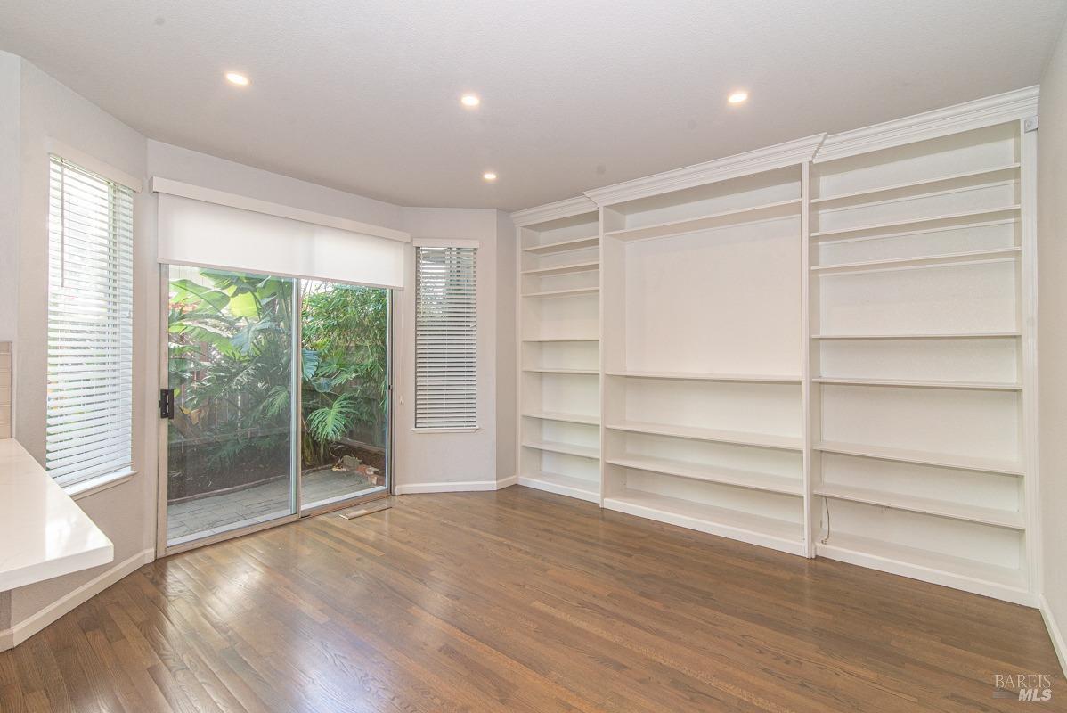23 Baypoint Drive San Rafael, CA 94901 - Photo 9 of 40 a view of an empty room with a window and wooden floor