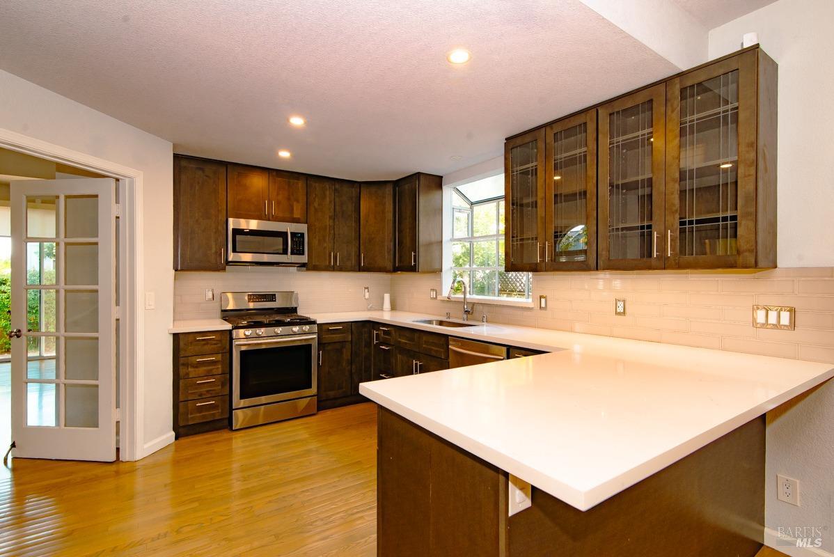 23 Baypoint Drive San Rafael, CA 94901 - Photo 10 of 40 a kitchen with stainless steel appliances granite countertop a sink stove and refrigerator