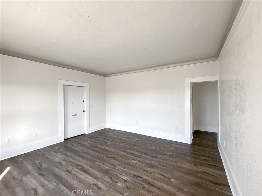 800 Pacific Avenue, Unit 300 Long Beach, CA 90813 - Photo 13 of 20 a view of an empty room with wooden floor