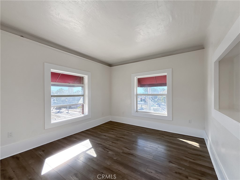 800 Pacific Avenue, Unit 300 Long Beach, CA 90813 - Photo 16 of 20 a view of an empty room with wooden floor and a window
