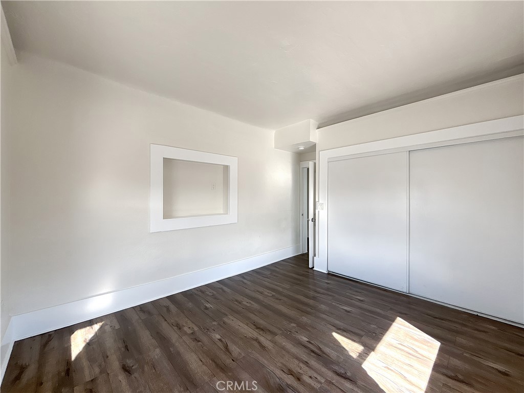 800 Pacific Avenue, Unit 300 Long Beach, CA 90813 - Photo 17 of 20 an empty room with wooden floor closet and windows