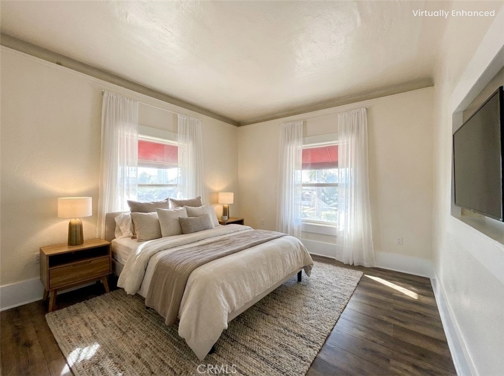 800 Pacific Avenue, Unit 300 Long Beach, CA 90813 - Photo 3 of 20 a bedroom with bed and a flat tv screen on a dresser